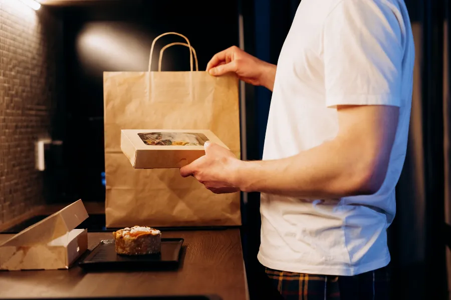 A takeaway order being unpacked from a paper bag